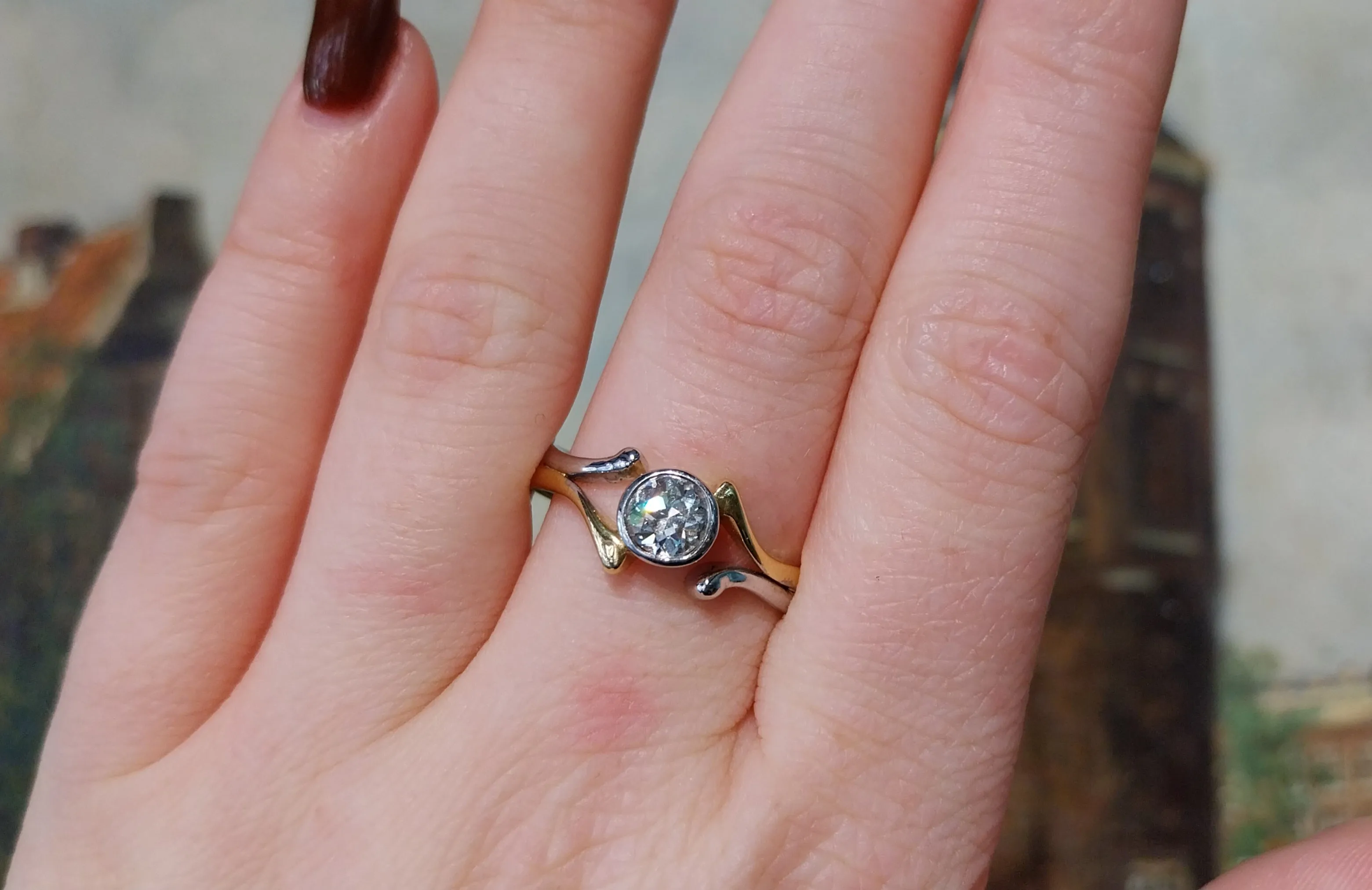 Old cut diamond solitaire ring in white and yellow gold.