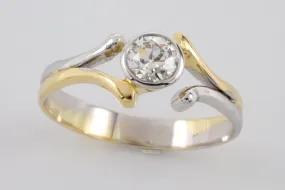 Old cut diamond solitaire ring in white and yellow gold.