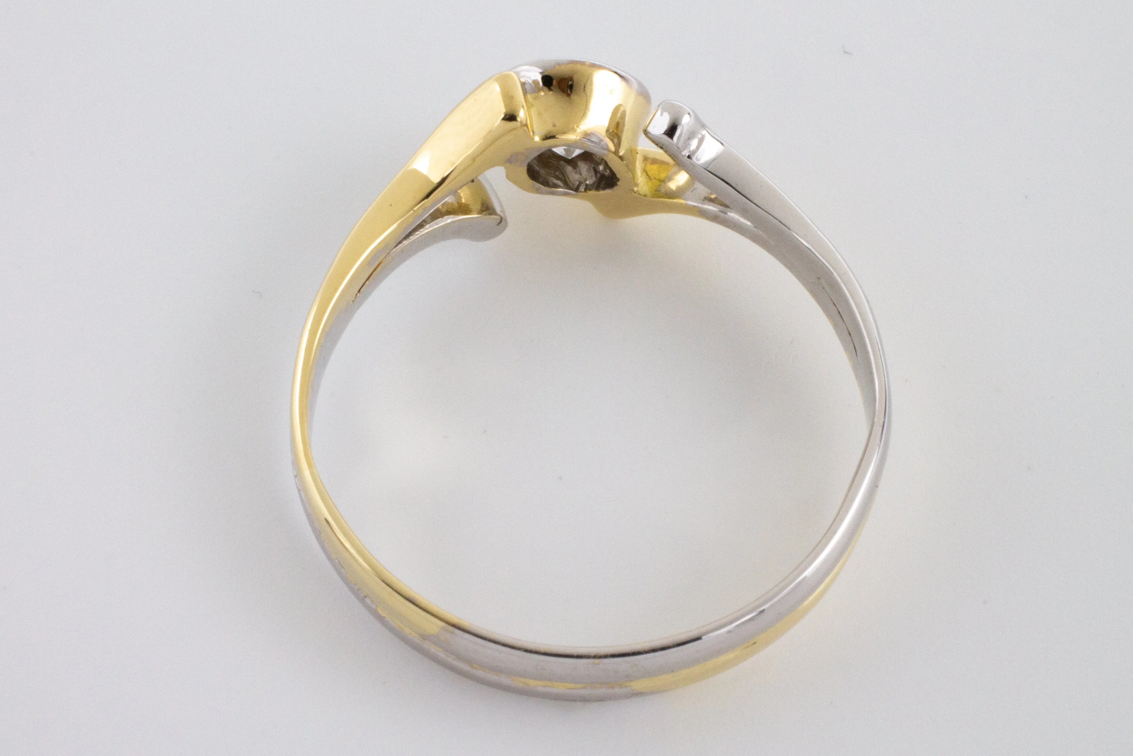 Old cut diamond solitaire ring in white and yellow gold.