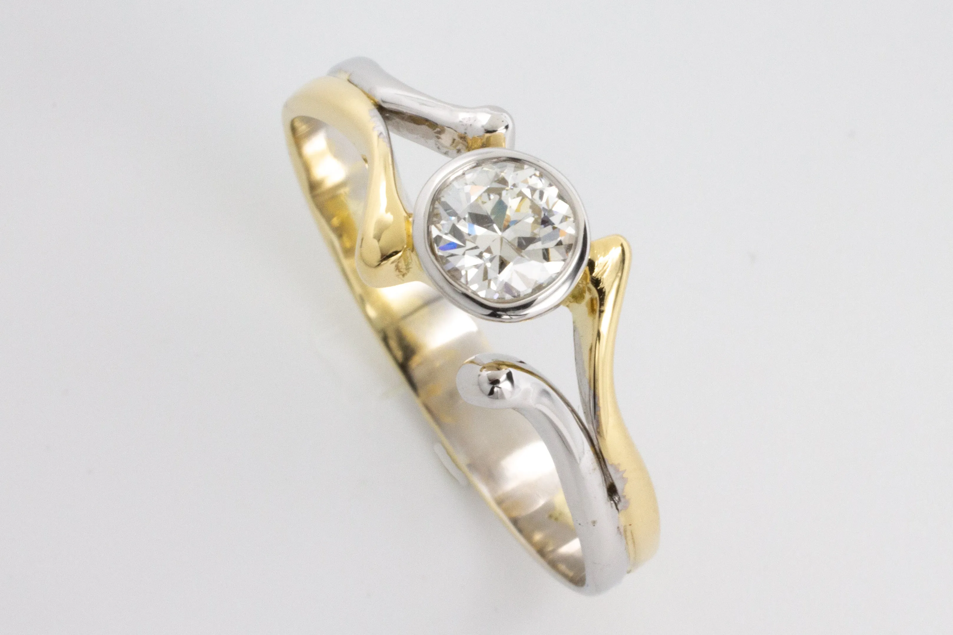 Old cut diamond solitaire ring in white and yellow gold.